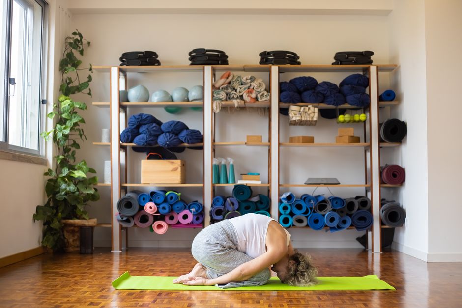A fully supported restorative yoga shape using bolsters and blankets