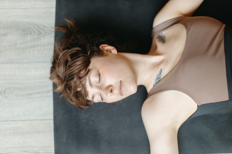 A student resting with an eye pillow during restorative yoga