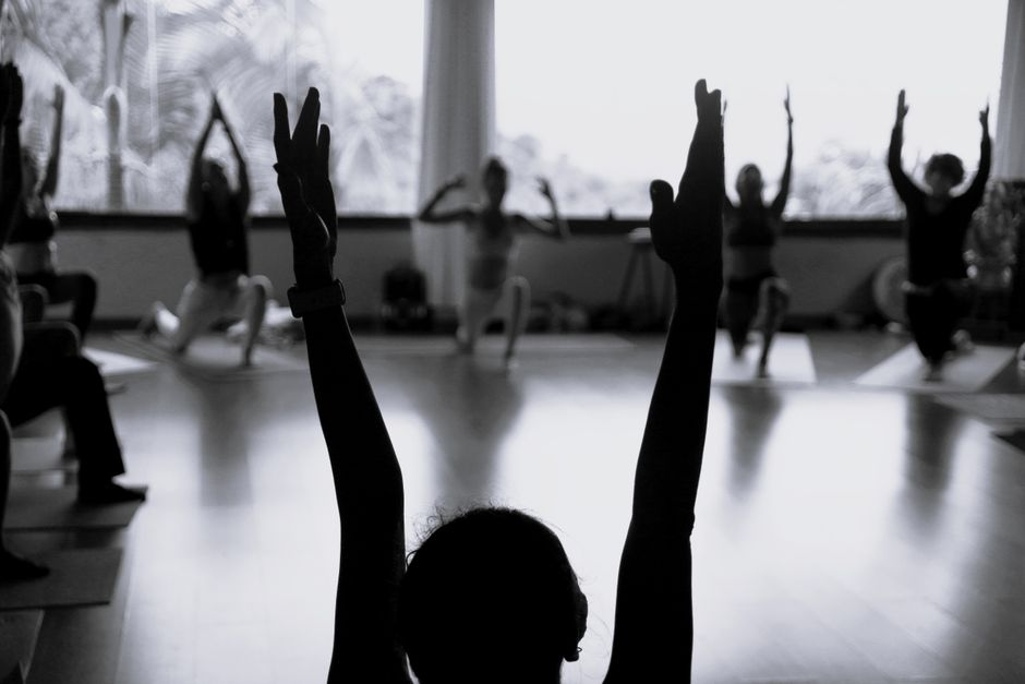 Soft lighting over a restorative yoga class
