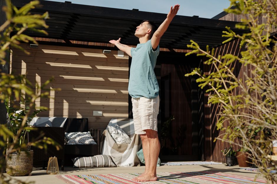 A standing sun salutation pose in morning light